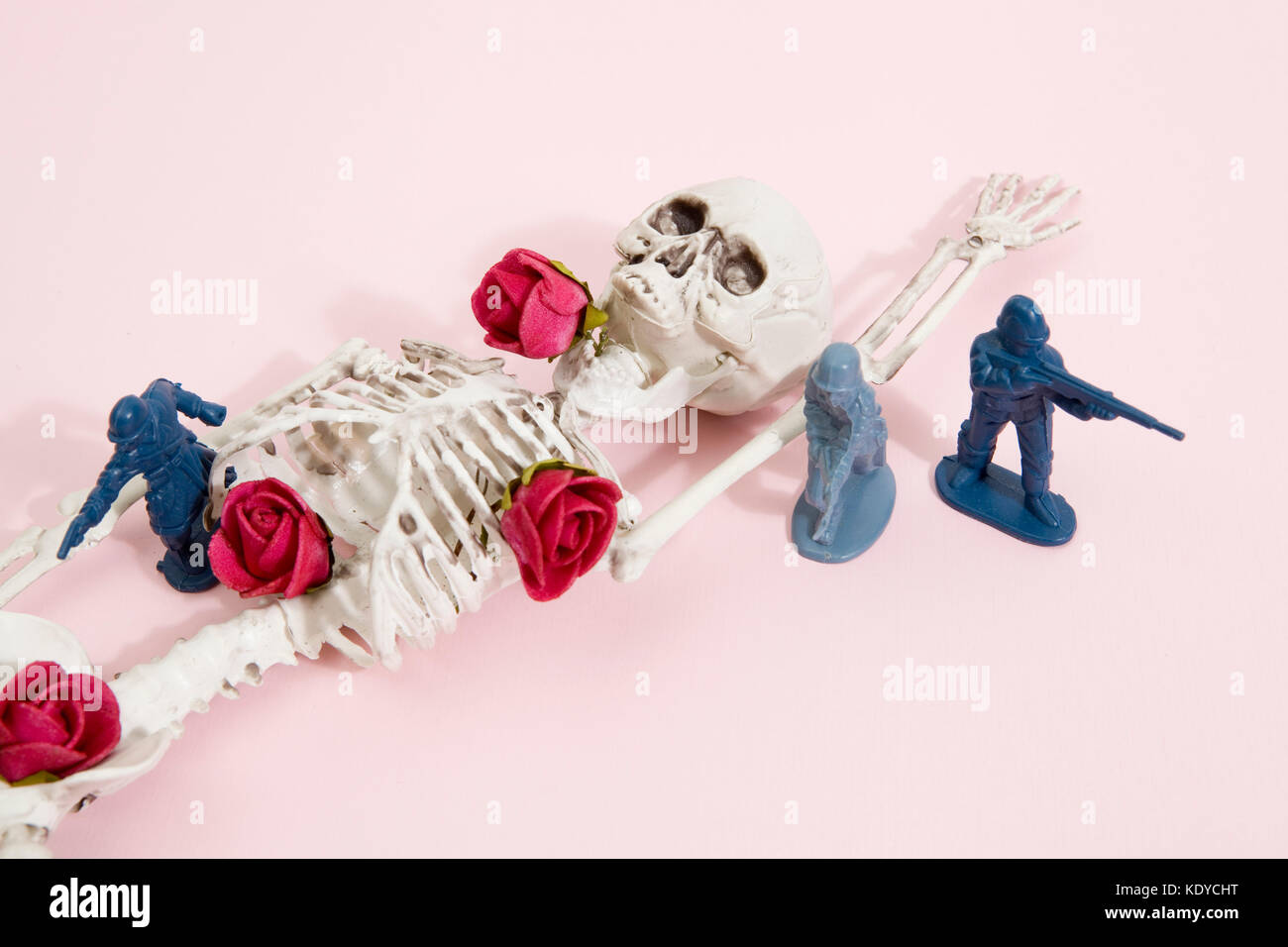 Plastic toy Soldiers around a pop skeleton wearing flower roses on a pop vibrant pink background. Minimal color still life photography Stock Photo - Alamy Plastic toy Soldiers around a pop skeleton wearing flower roses on a pop vibrant pink background. Minimal color still life photography Stock Photo - Alamy