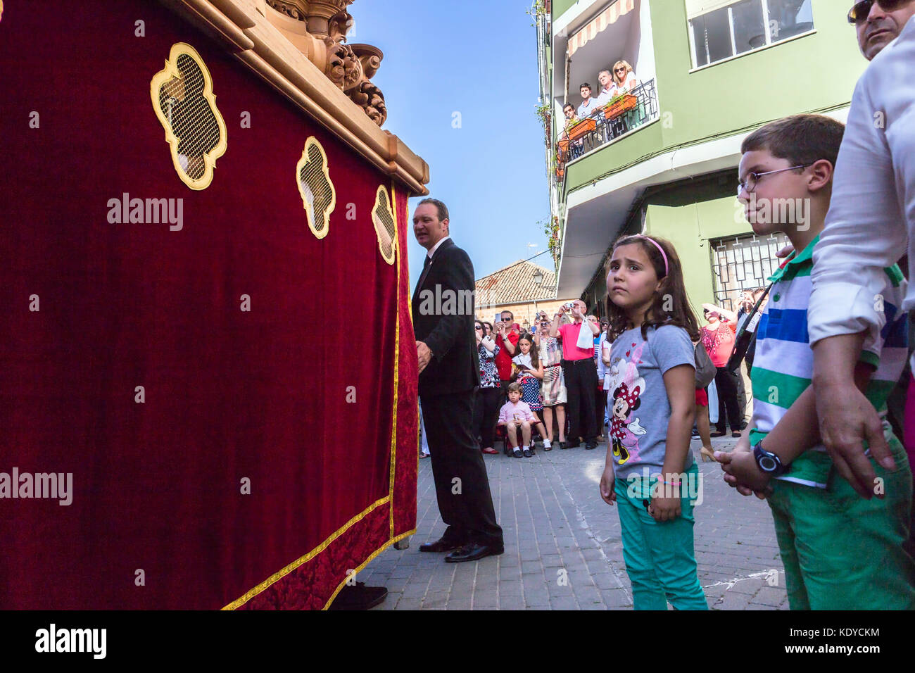 Girl tries to touch the skirt of the throne to have good luck, popular tradition in Andalusia, Easter procession on Holy Thursday, taken in Linares, J Stock Photo