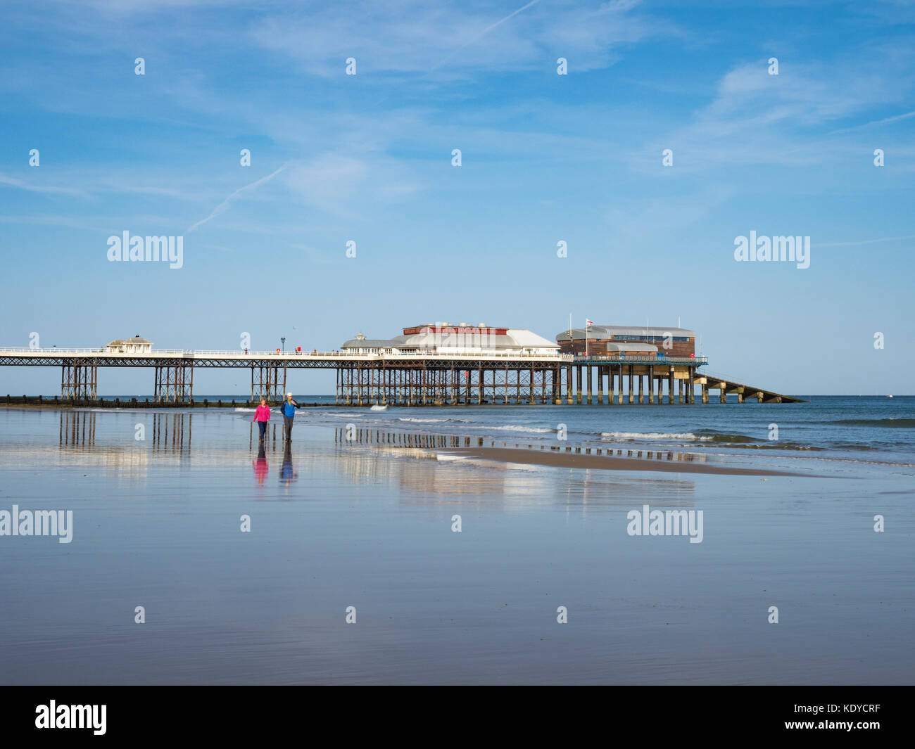 Couple walking on thte beach at sunny Cromer, Norfolk, England, Stock Photo