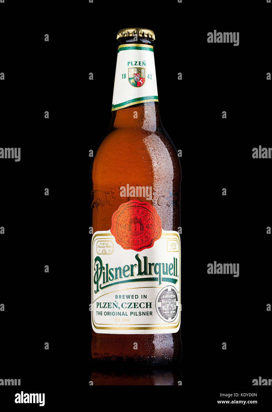 LONDON,UK - MARCH 21, 2017 :  Bottle of Pilsner Urquell beer on black background.It has been produced since 1842 in Pilsen, Czech Republic. Stock Photo