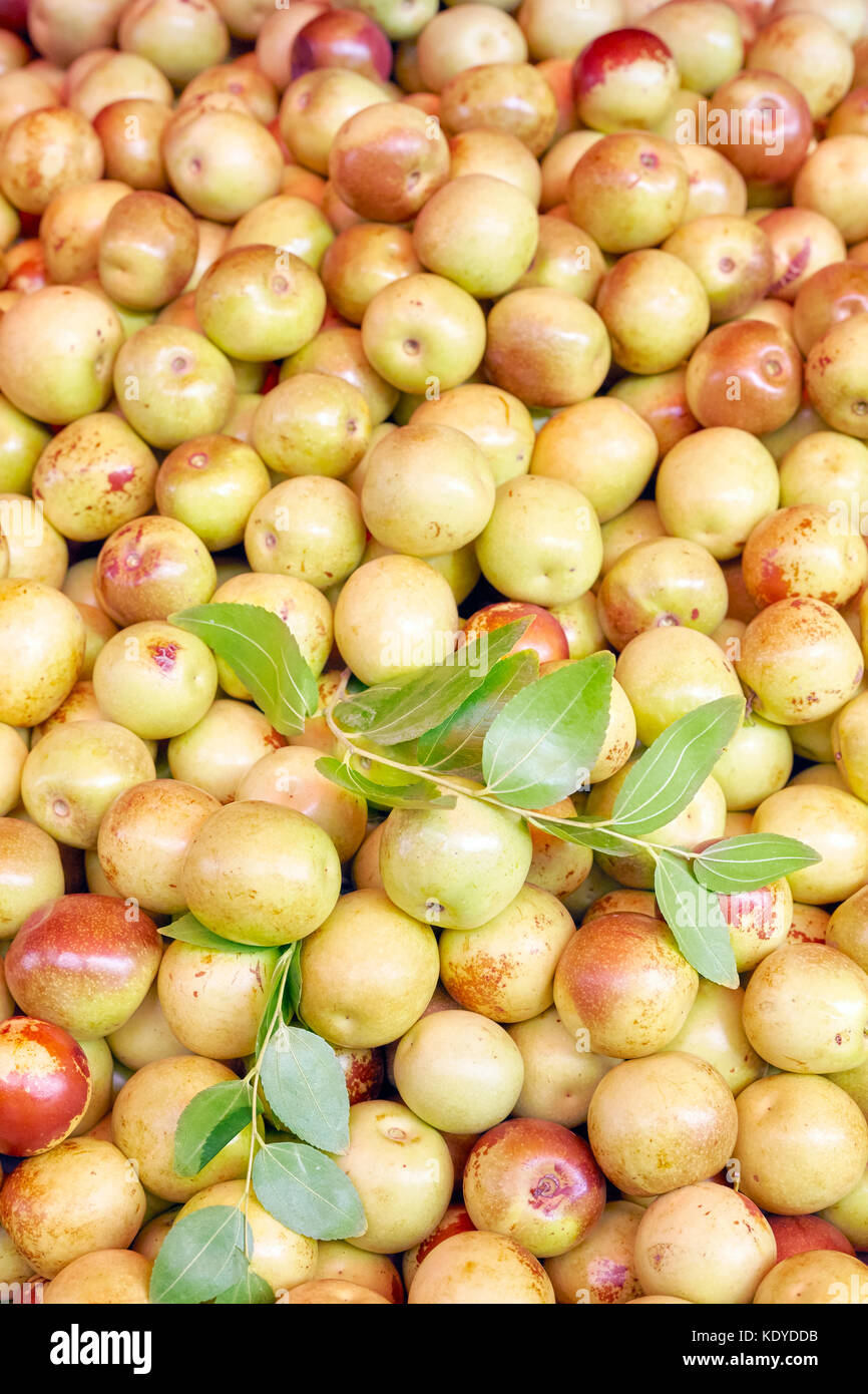 Jujube (Ziziphus jujuba) also called as Chinese apple fruits on a local market, selective focus. Stock Photo
