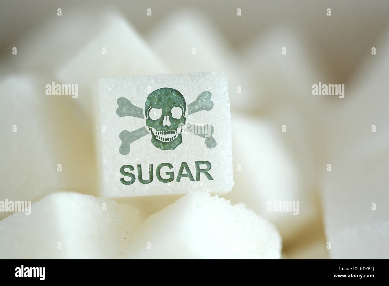 Sugar cubes with human skull symbol, suggesting unhealthy and dangerous food Stock Photo