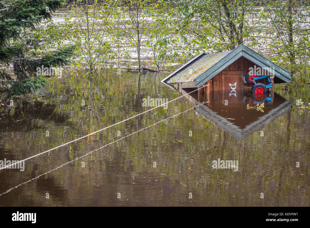 Small Cabin Floating In The Water Tied With A Rope Flooding From