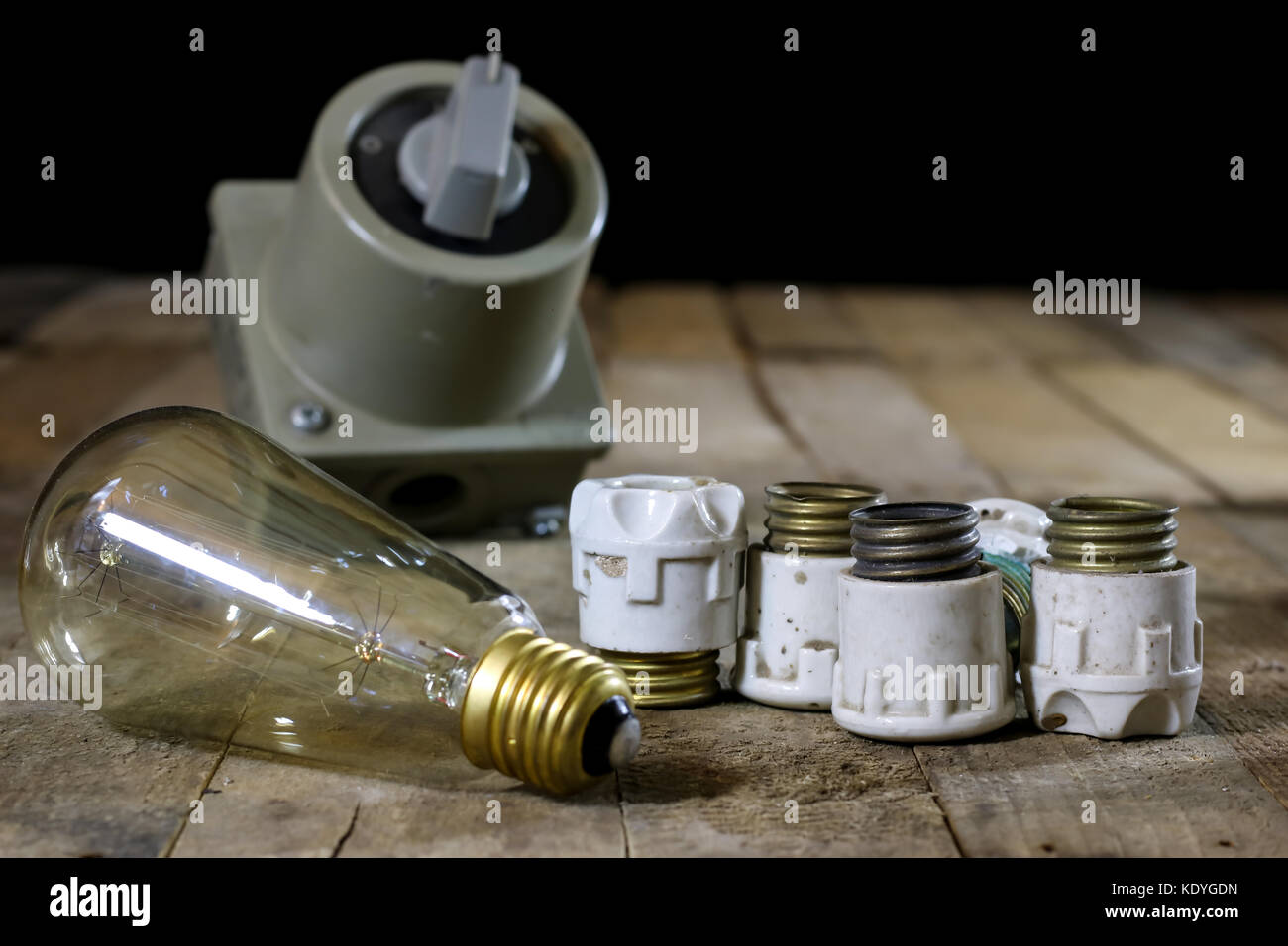 Old ceramic fuse holders. Old electrical accessories. Wooden table, black background - Stock