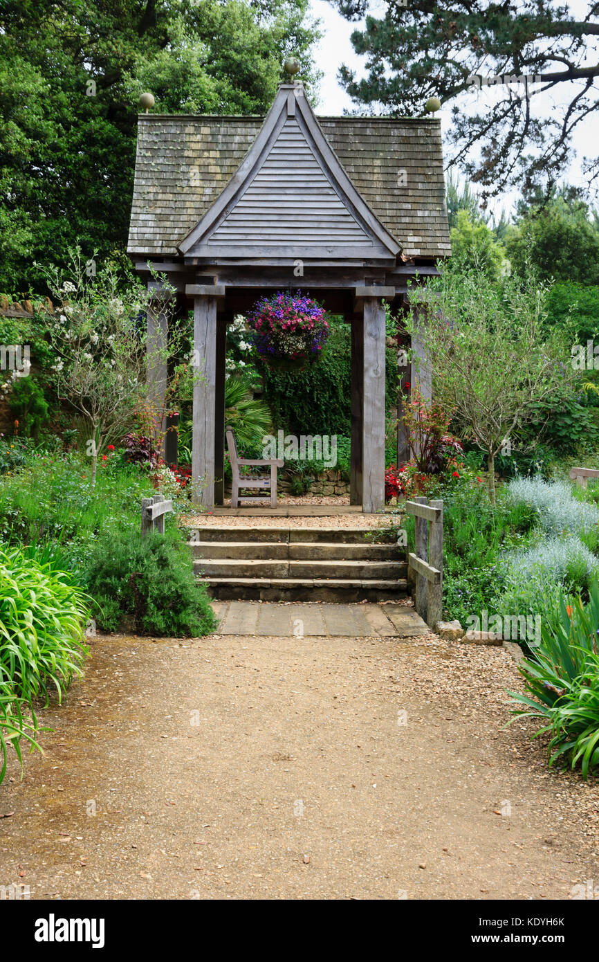 Wood and tile gazebo allows visitors to sit and contemplate in Abbotsbury Subtropical Gardens, Dorset,UK Stock Photo