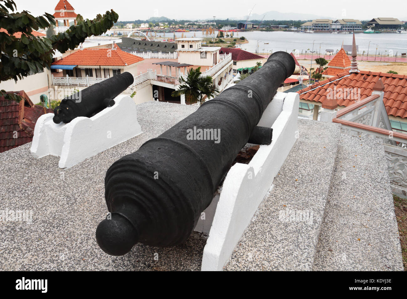Big and small cannons at Putri Hill in Kuala Terengganu, Malaysia. The pair is locally know as the 'The Cannon that gave birth'. Stock Photo