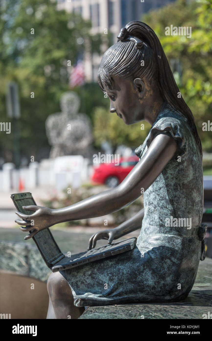 Outdoor sculpture of a girl with a laptop computer in front of the Boys & Girls Club of America headquarters on Peachtree Street in Midtown Atlanta. Stock Photo