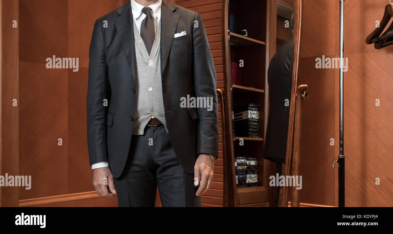 Stylish man in suit in wardrobe Stock Photo