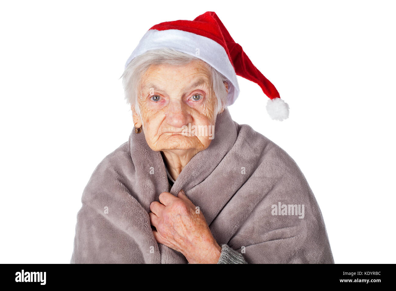 Elderly woman with Alzheimer disease holding a warm blanket and wearing