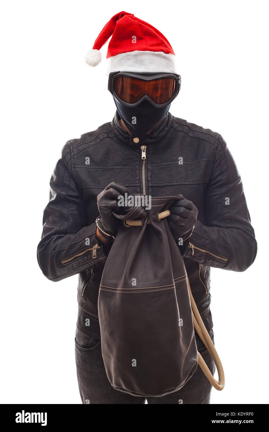 Masked burglar with santa claus cap holding his sack, posing on isolated background Stock Photo
