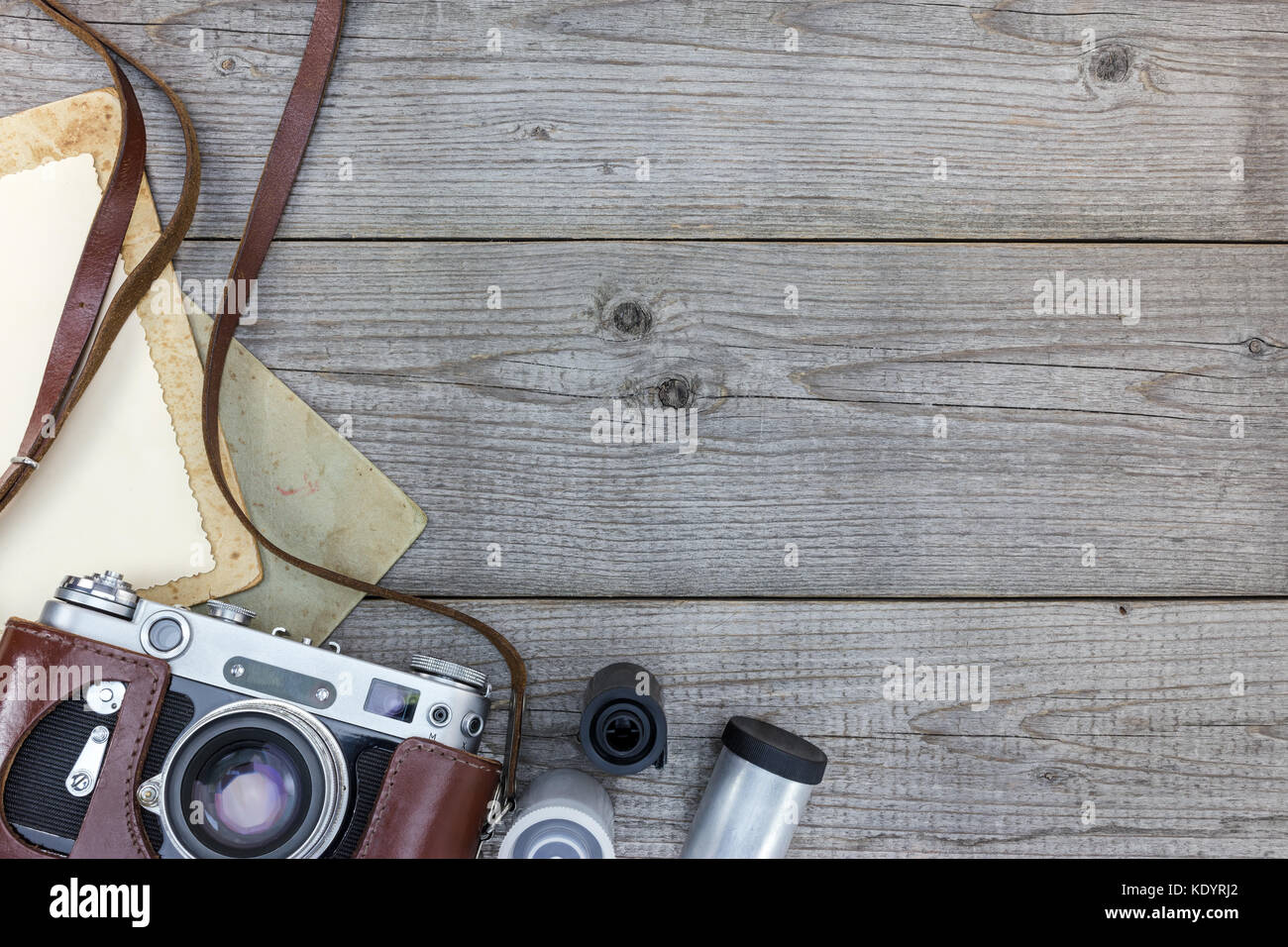retro still camera and empty instant paper on wooden background flat view Stock Photo
