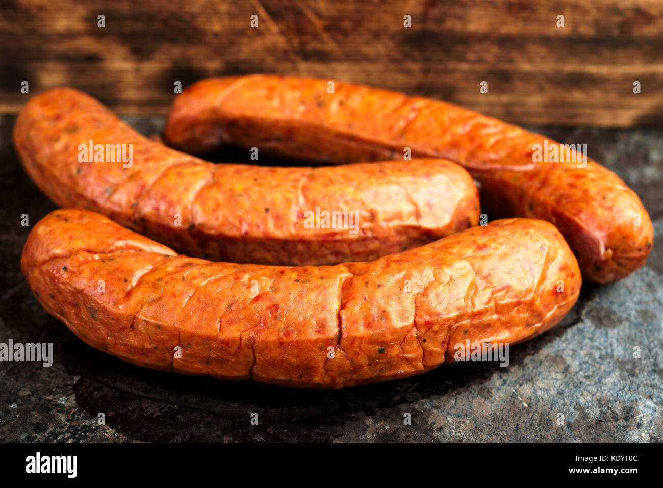 Three deliciously smoked handmade Swedish Isterband sausages with natural casing. Stock Photo