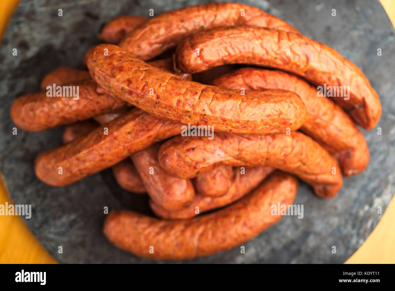 Large pile of deliciously smoked handmade Swedish Isterband sausages with natural casing. Stock Photo