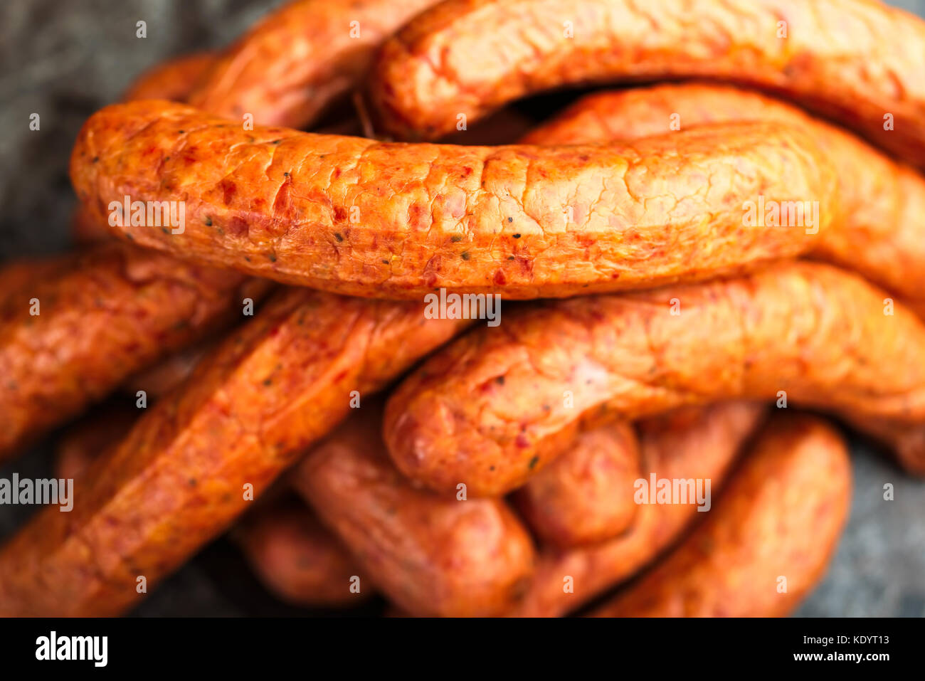 Large pile of deliciously smoked handmade Swedish Isterband sausages with natural casing. Stock Photo