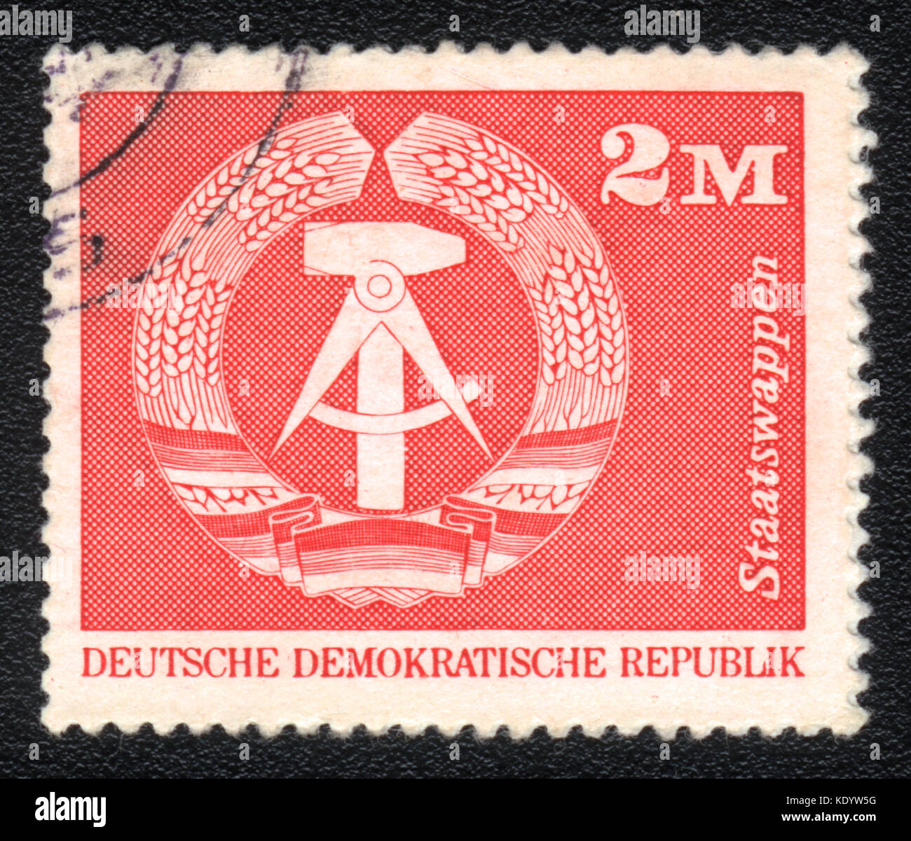 A postage stamp printed in DDR shows Emblem of the DDR, circa 1975 Stock Photo