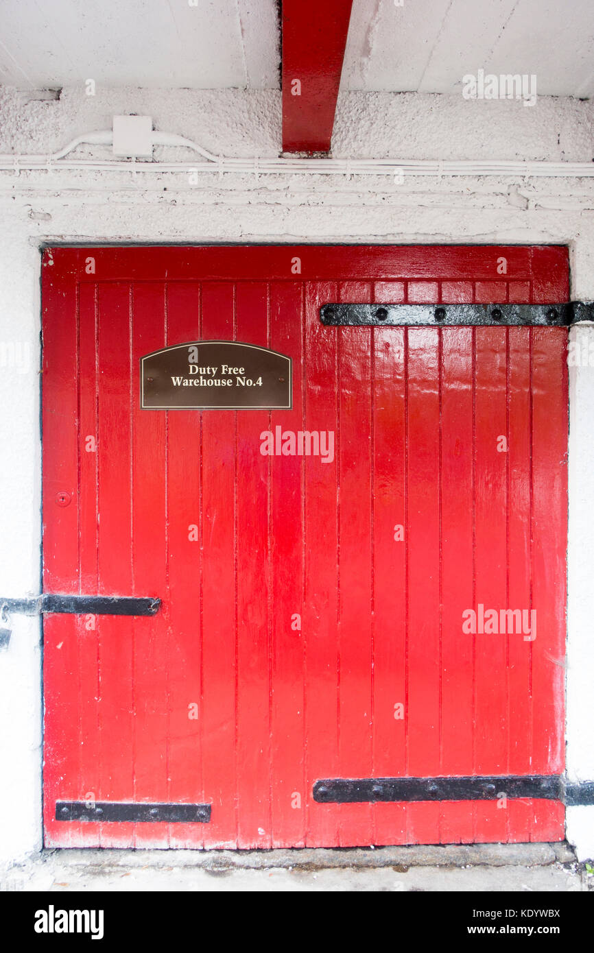 Red door entrance to Bonded warehouse No1 at Aberlour Whisky Distillery in the village of Aberlour, Speyside, Scotland Stock Photo