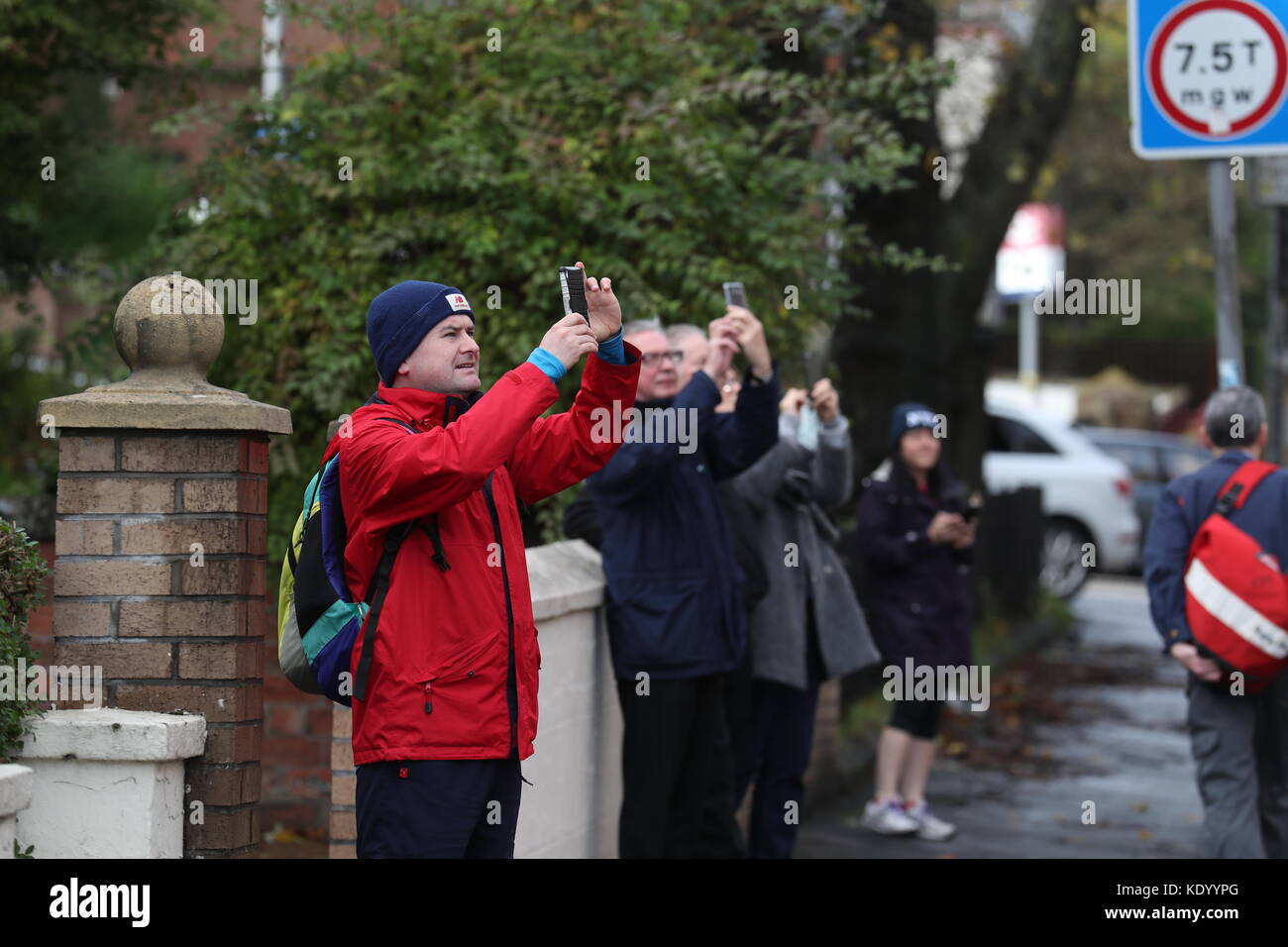 Memebers of the public take photos of the scene in Crosshill, in the south side of Glasgow, after the front of a block of flats, which are due for demolition, was brought down in high winds as Storm Ophelia sweeps across Scotland. Stock Photo