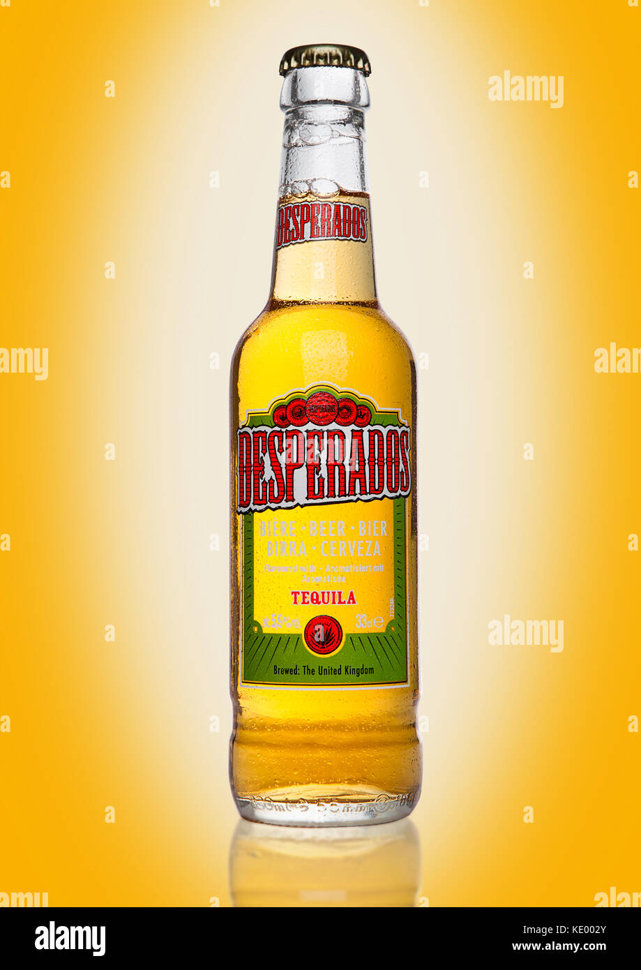 LONDON, UK - JANUARY 02, 2017: Bottle of Desperados beer on yellow background, lager flavored with tequila is a popular beer produced by Heineken and  Stock Photo