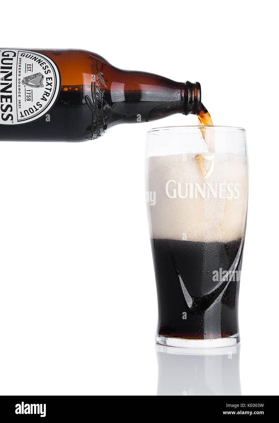 LONDON, UK - NOVEMBER 29, 2016: Guinness extra stout beer bottle on white background. Guinness beer has been produced since 1759 in Dublin, Ireland. Stock Photo