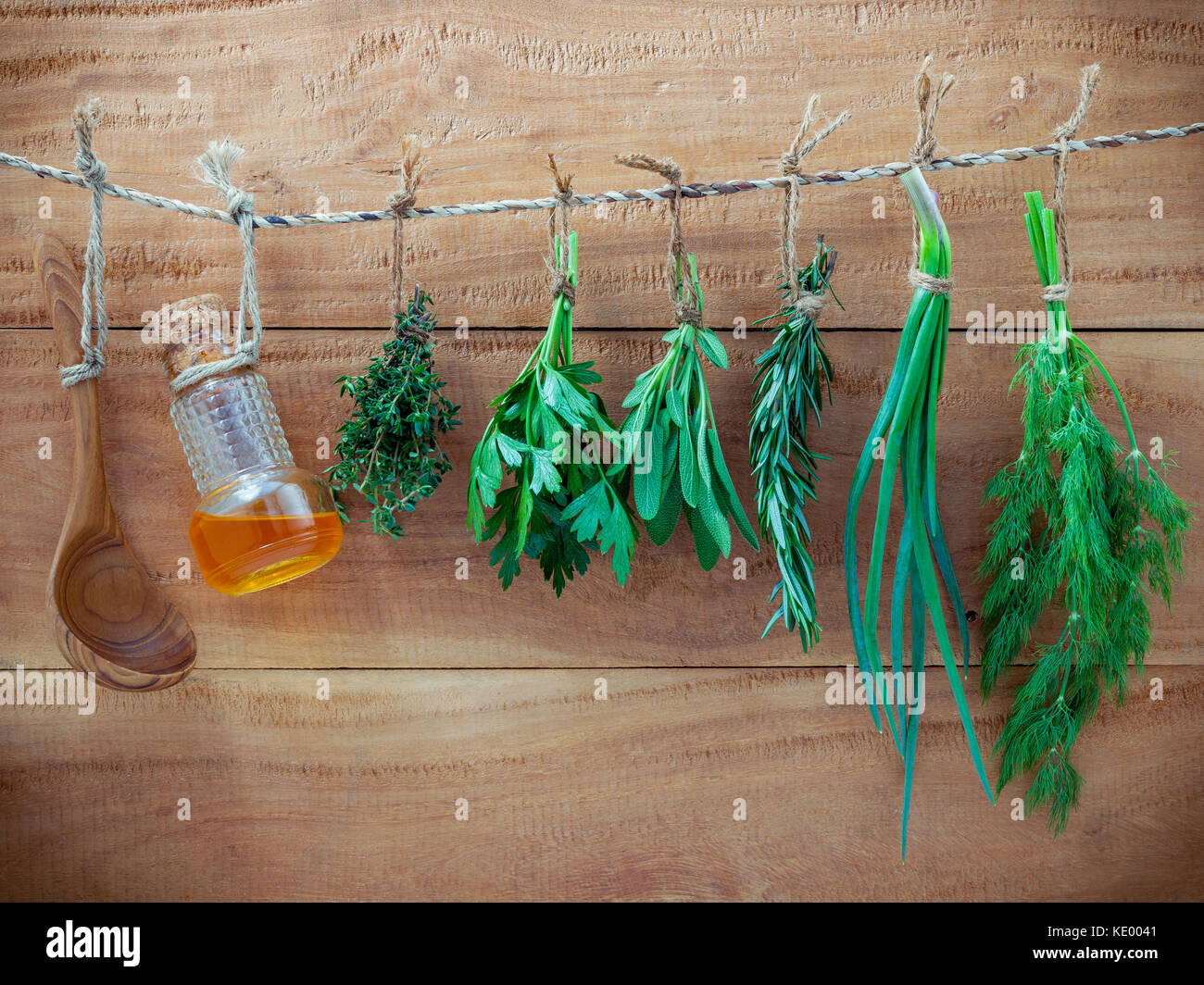 Various herbs hanging on shabby wooden background. Parsley ,sage