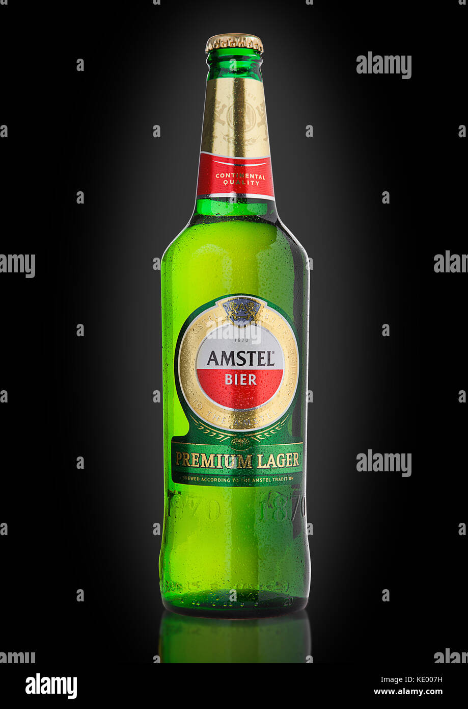 LONDON, UNITED KINGDOM - NOVEMBER 01, 2016: Cold bottle of Amstel Premium Lager on black background.Amstel is an internationally known brand of beer p Stock Photo