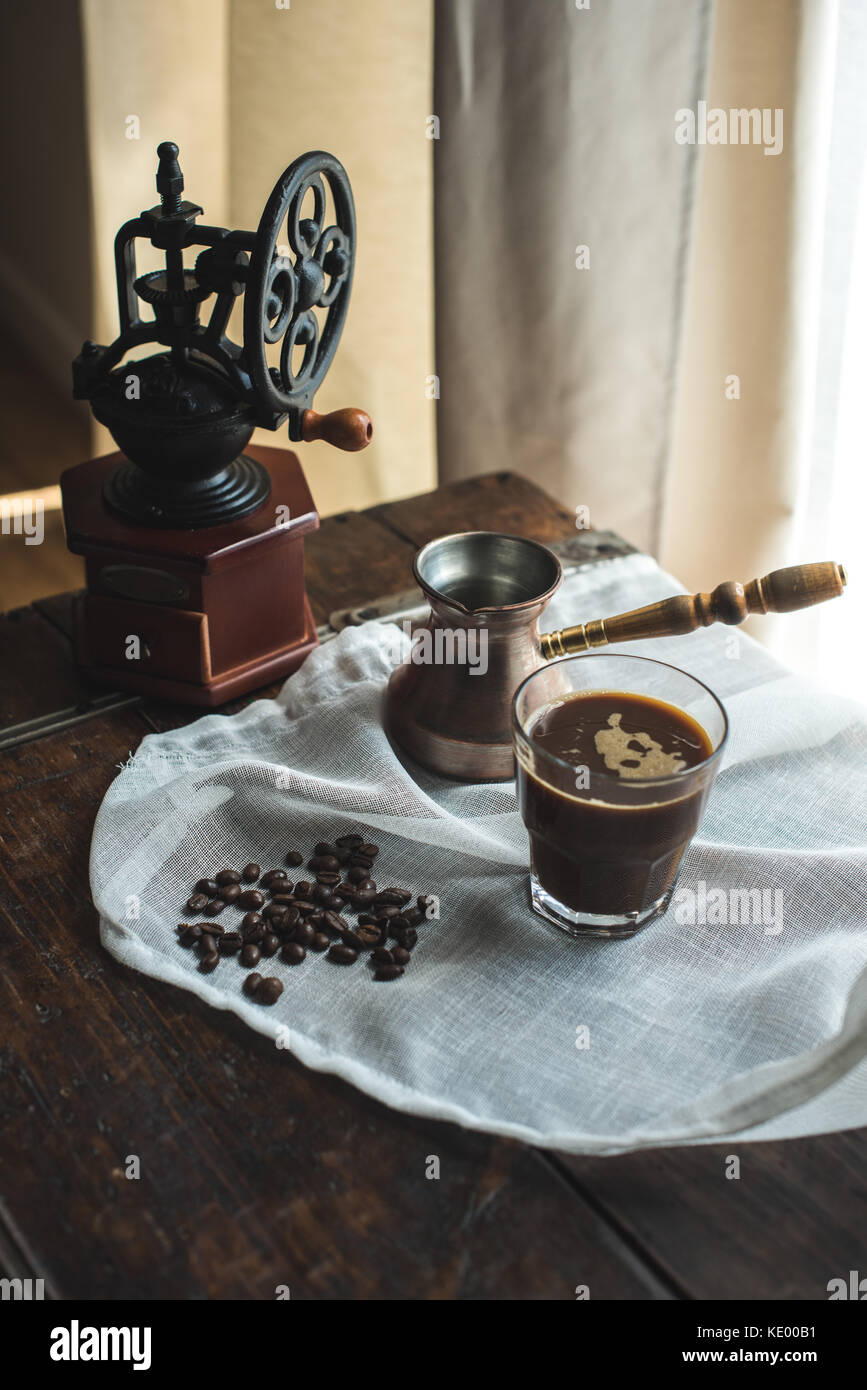 https://c8.alamy.com/comp/KE00B1/vintage-hand-mill-turkish-coffee-pot-with-glass-of-coffee-on-white-KE00B1.jpg