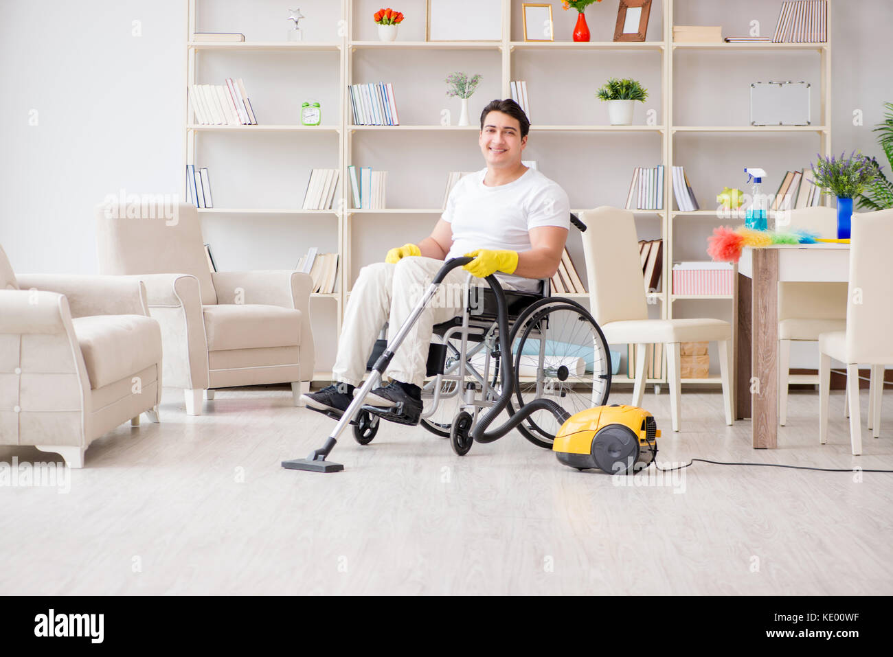 Disabled man with vacuum cleaner at home Stock Photo Alamy