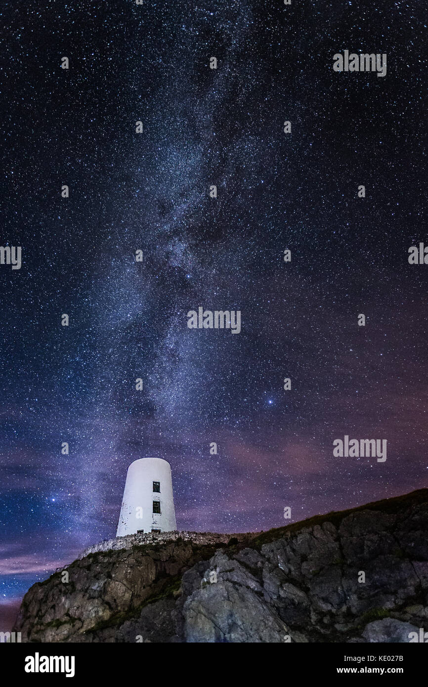 Llanddwyn Island Lighthouse (Ynys Llanddwyn) at night with Milky way with stars, Anglesey, Wales, UK Stock Photo