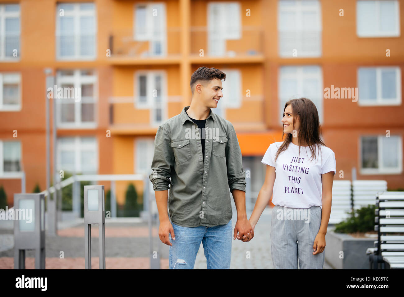 Trendy couple of lovers walking in the street Stock Photo