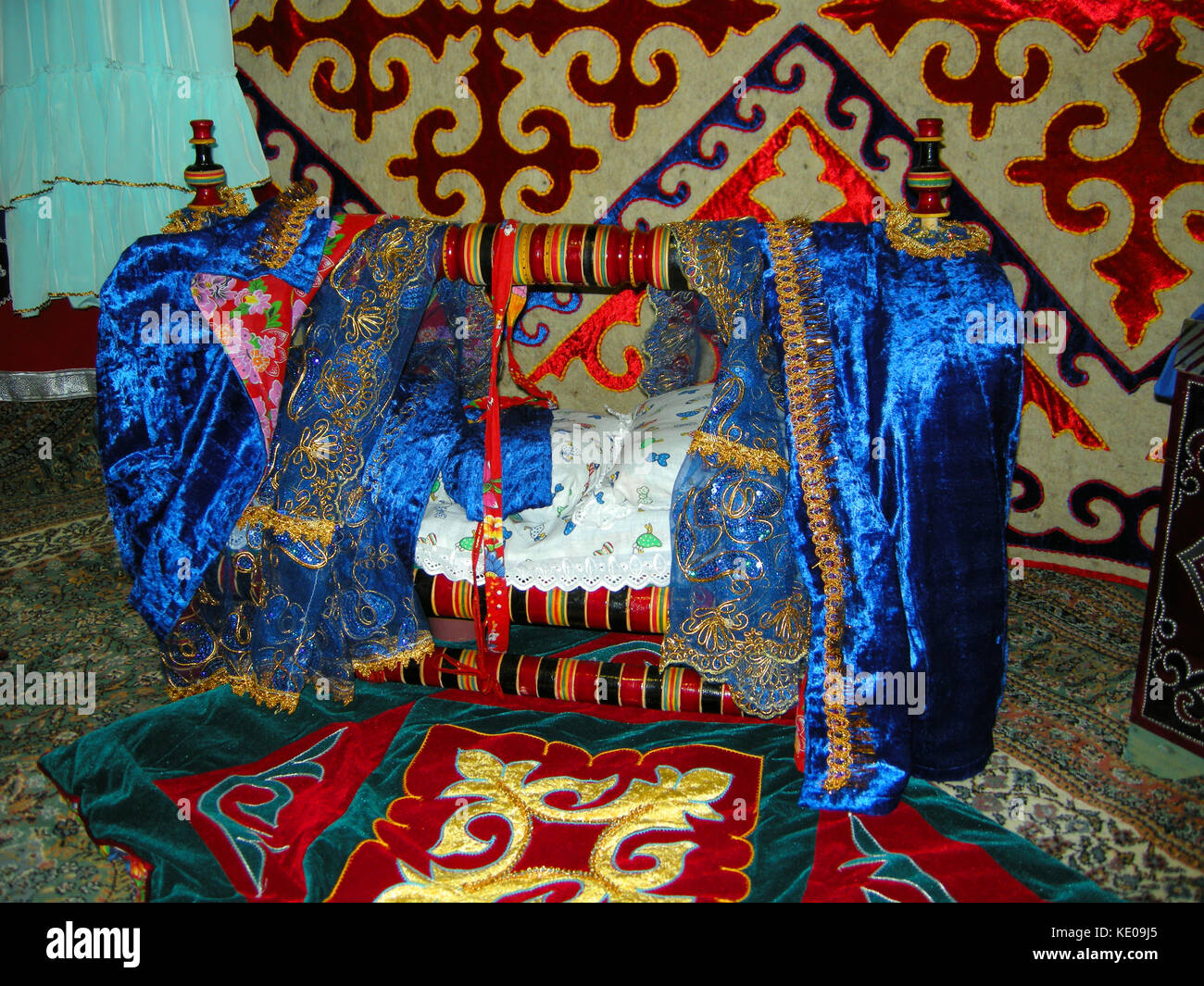A colourfully decorated baby’s crib on display at an exhibit in the