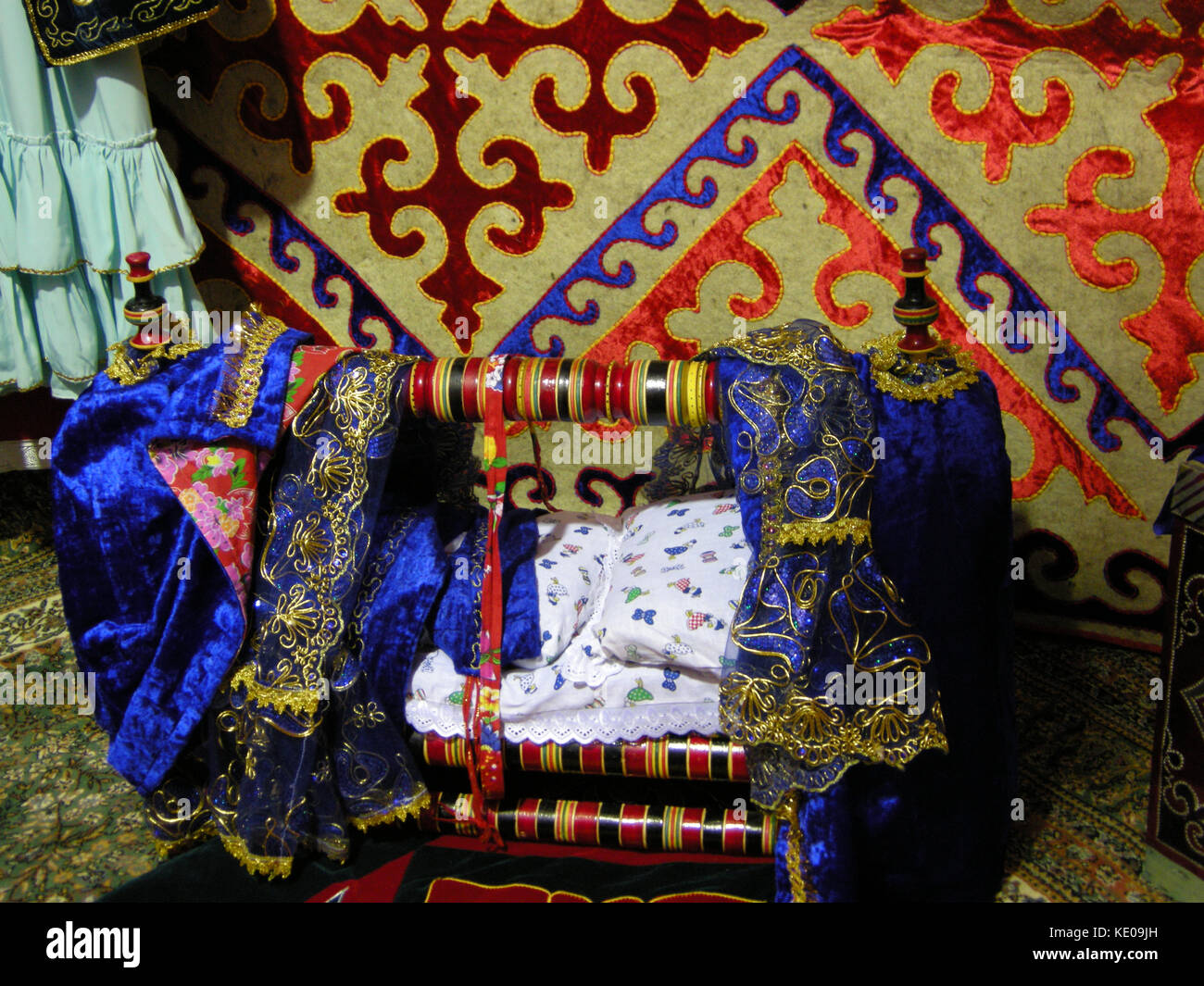 A colourfully decorated baby’s crib on display at an exhibit in the