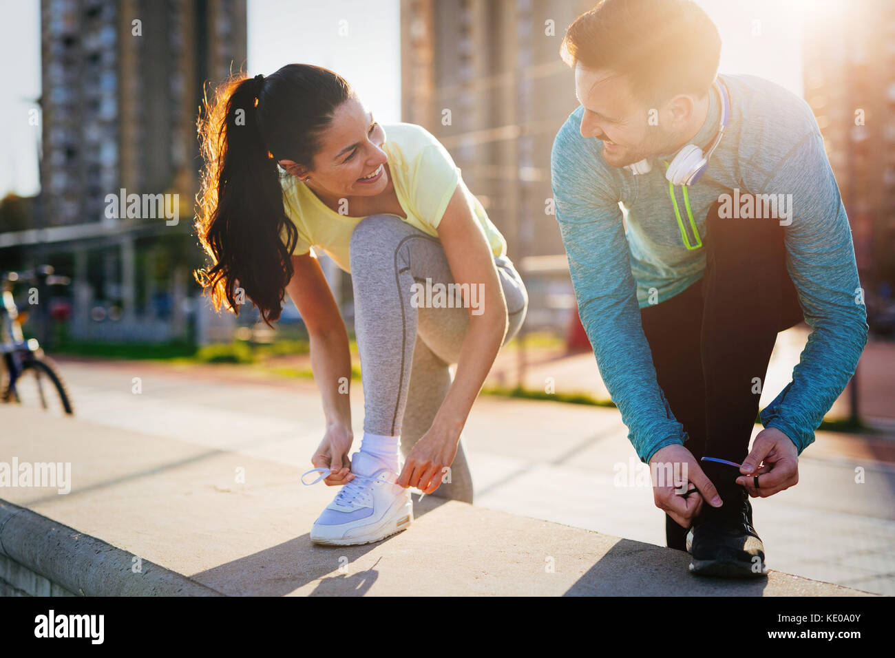 Runners tying running shoes and getting ready to run Stock Photo