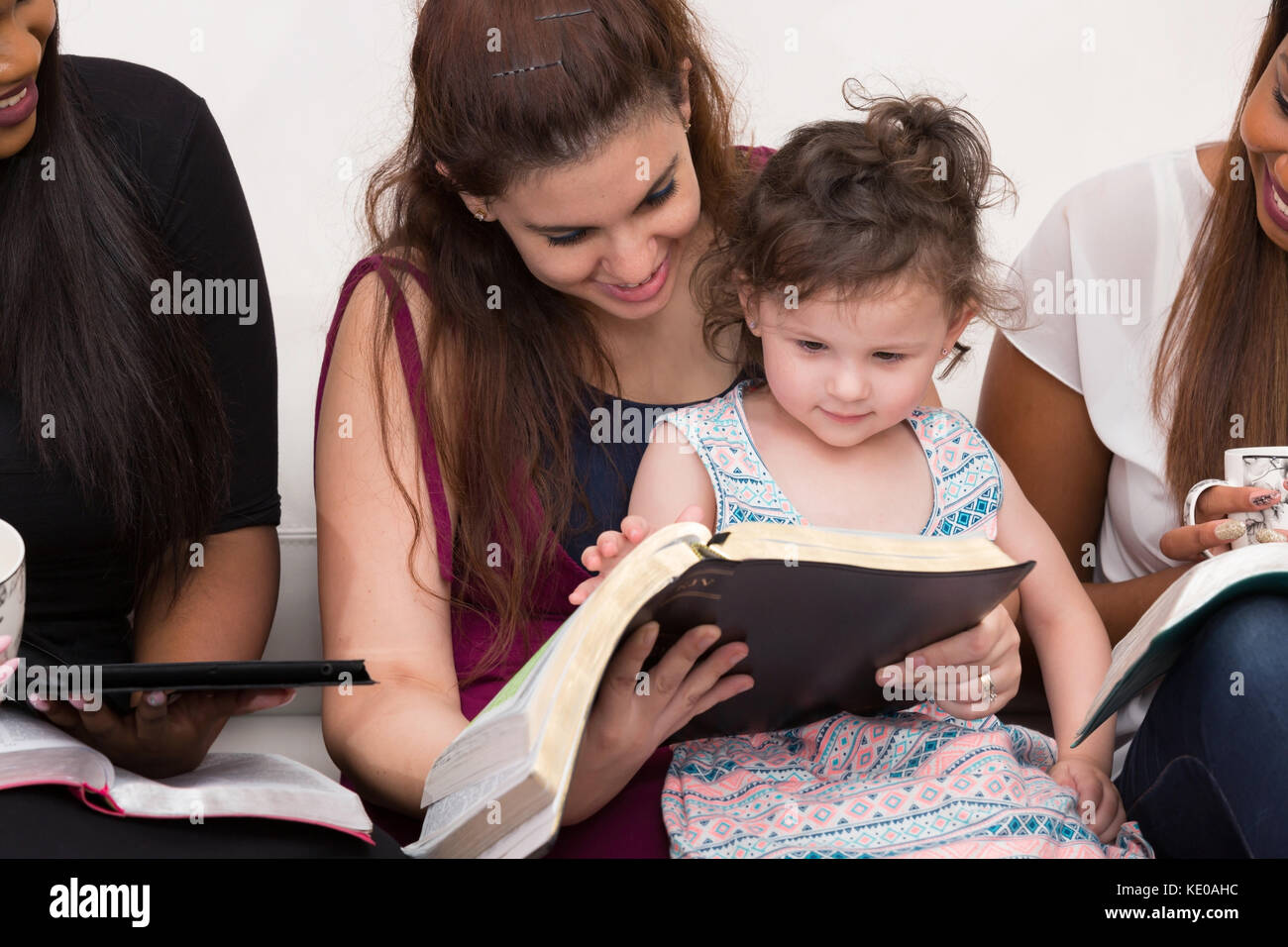 Women Studying The Word Of God With Child Stock Photo