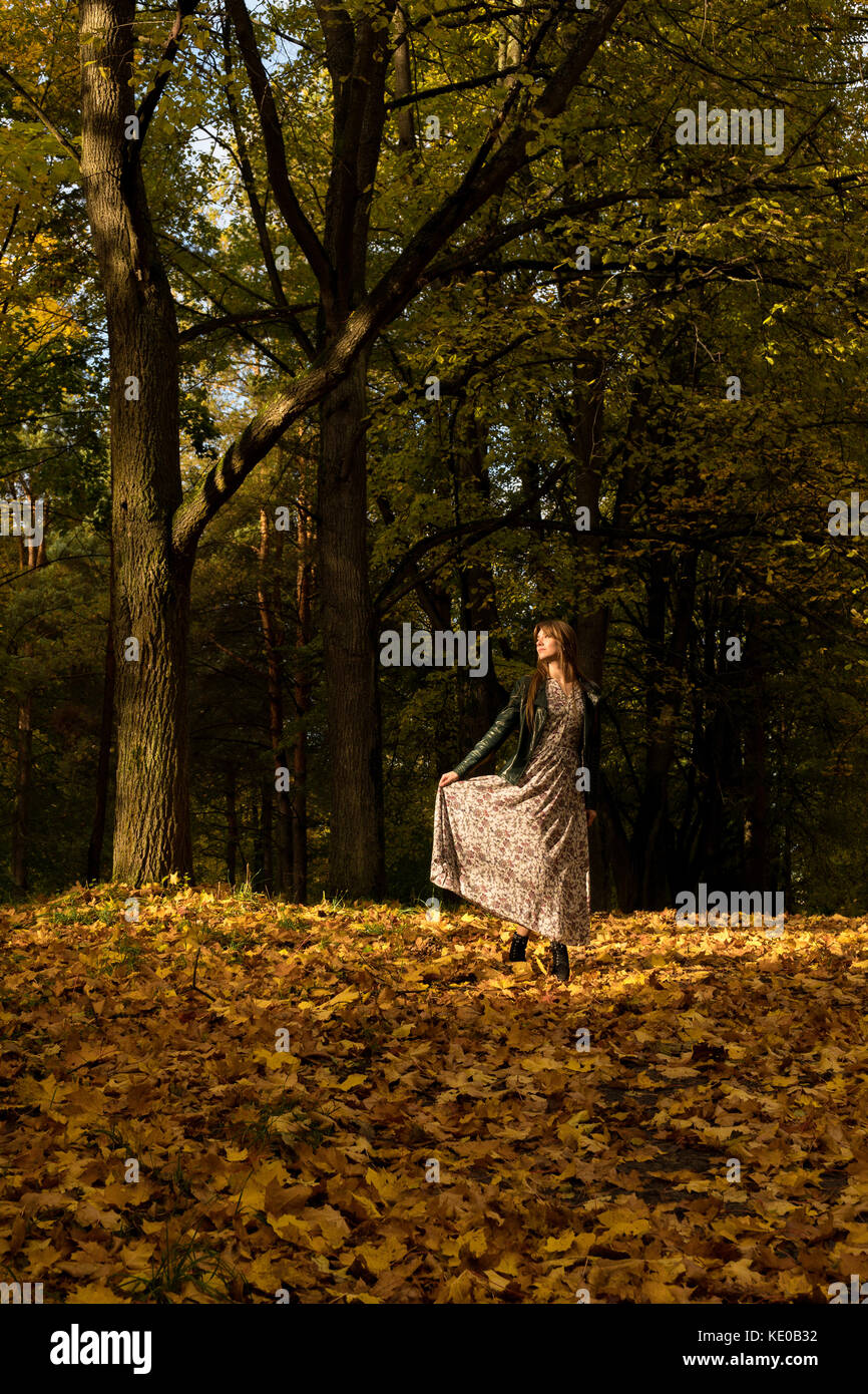 A girl is walking in an autumn forest Stock Photo - Alamy