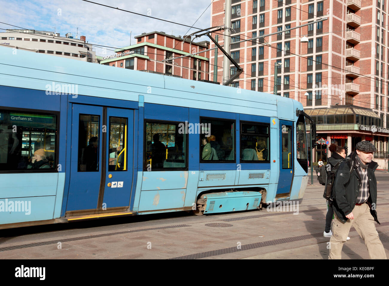 A tram moving away from tram stop in the centre of Oslo