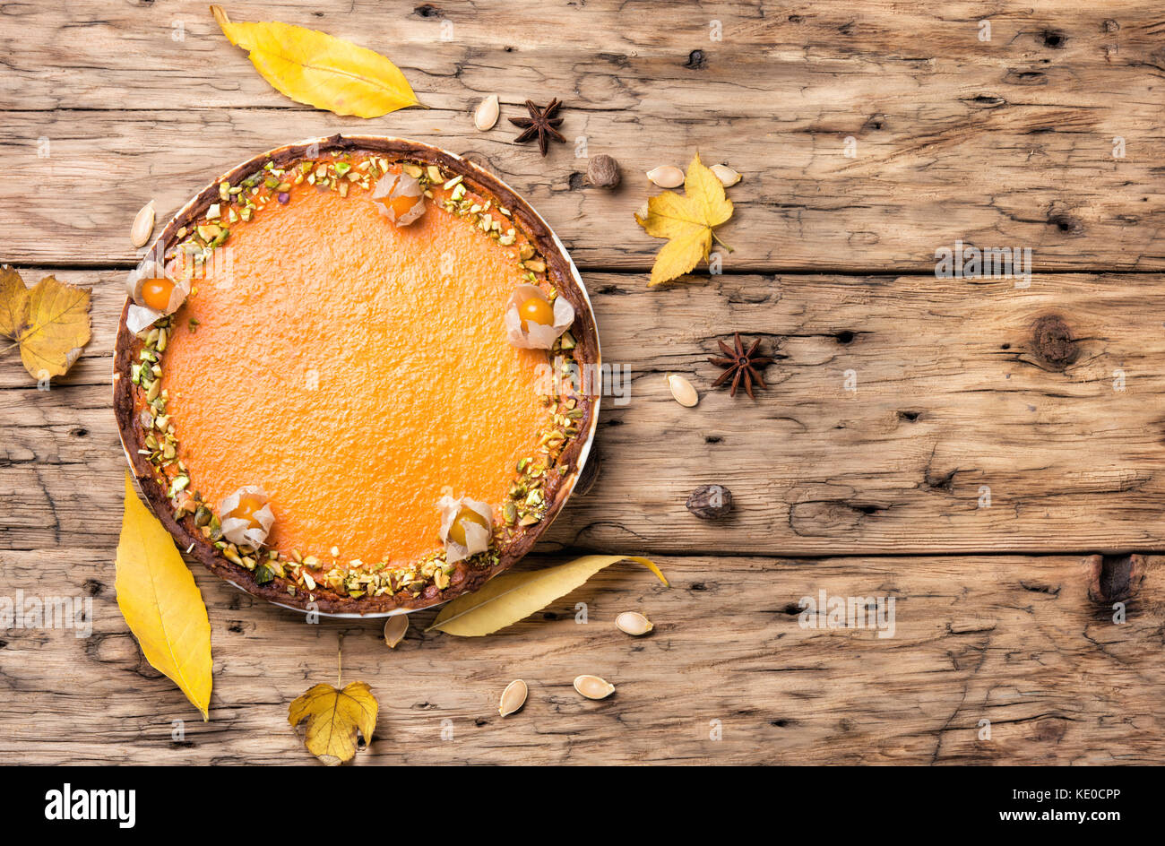 rustic autumn pie from a pumpkin on a wooden background Stock Photo - Alamy