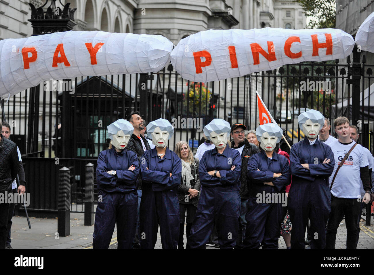 London, UK. 17th Oct, 2017. Public sector workers, several wearing masks depicting Theresa May, Prime Minister, as a 'MayBot' outside the Downing Street ahead of a rally in Parliament Square against the cap on public sector workers' pay. Credit: Stephen Chung/Alamy Live News Stock Photo