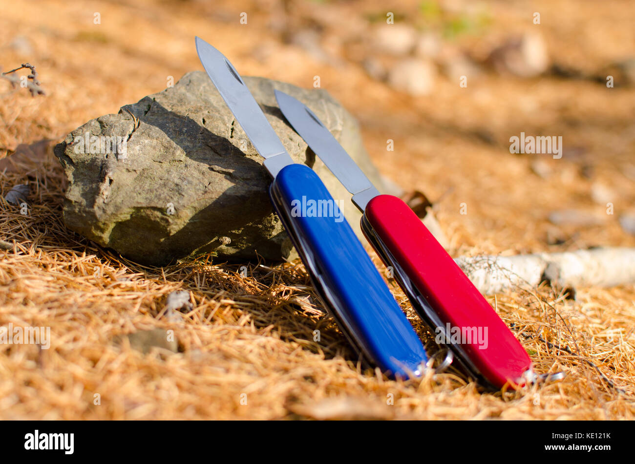 pocket knives on a stone Stock Photo