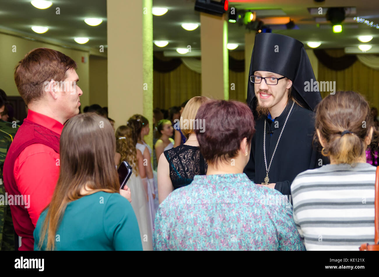 Komsomolsk-on-Amur, 15-01-2016, Sretensky Ball. Orthodox priest talking to people at the feast. Stock Photo