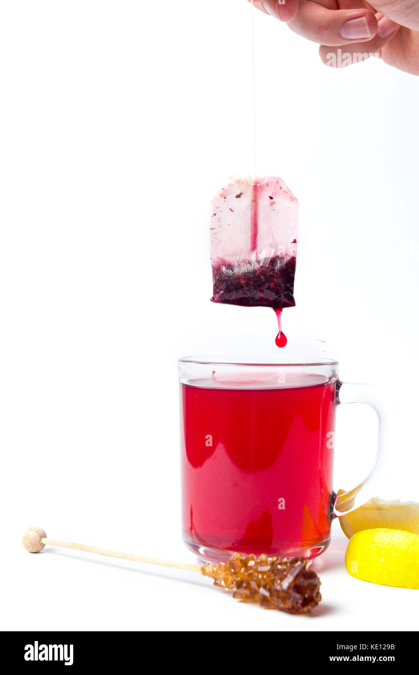 Hand taking out tea bag out of the glass isolated Stock Photo Alamy