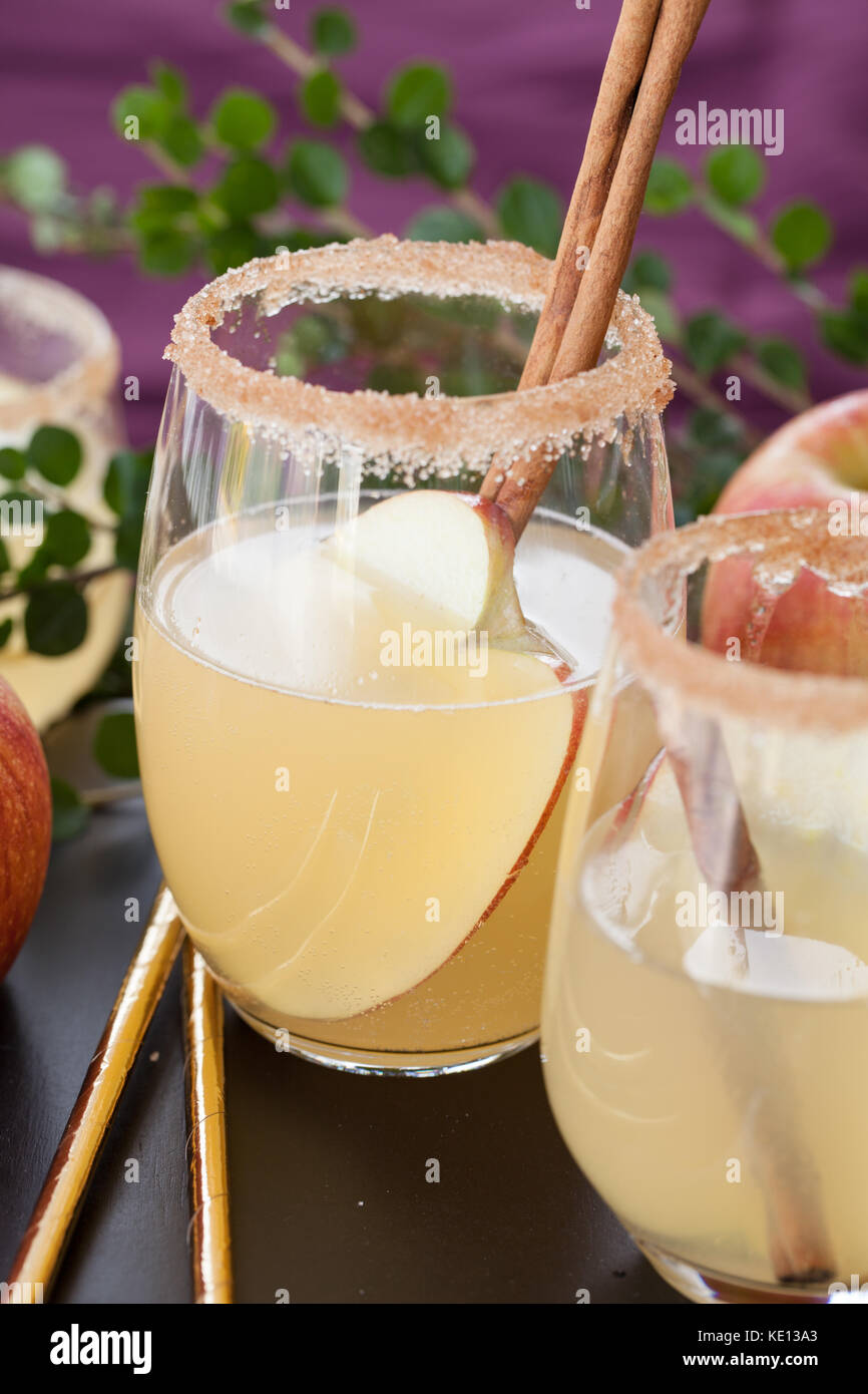 Fruity cocktail with apple and cinnamon sticks Stock Photo Alamy
