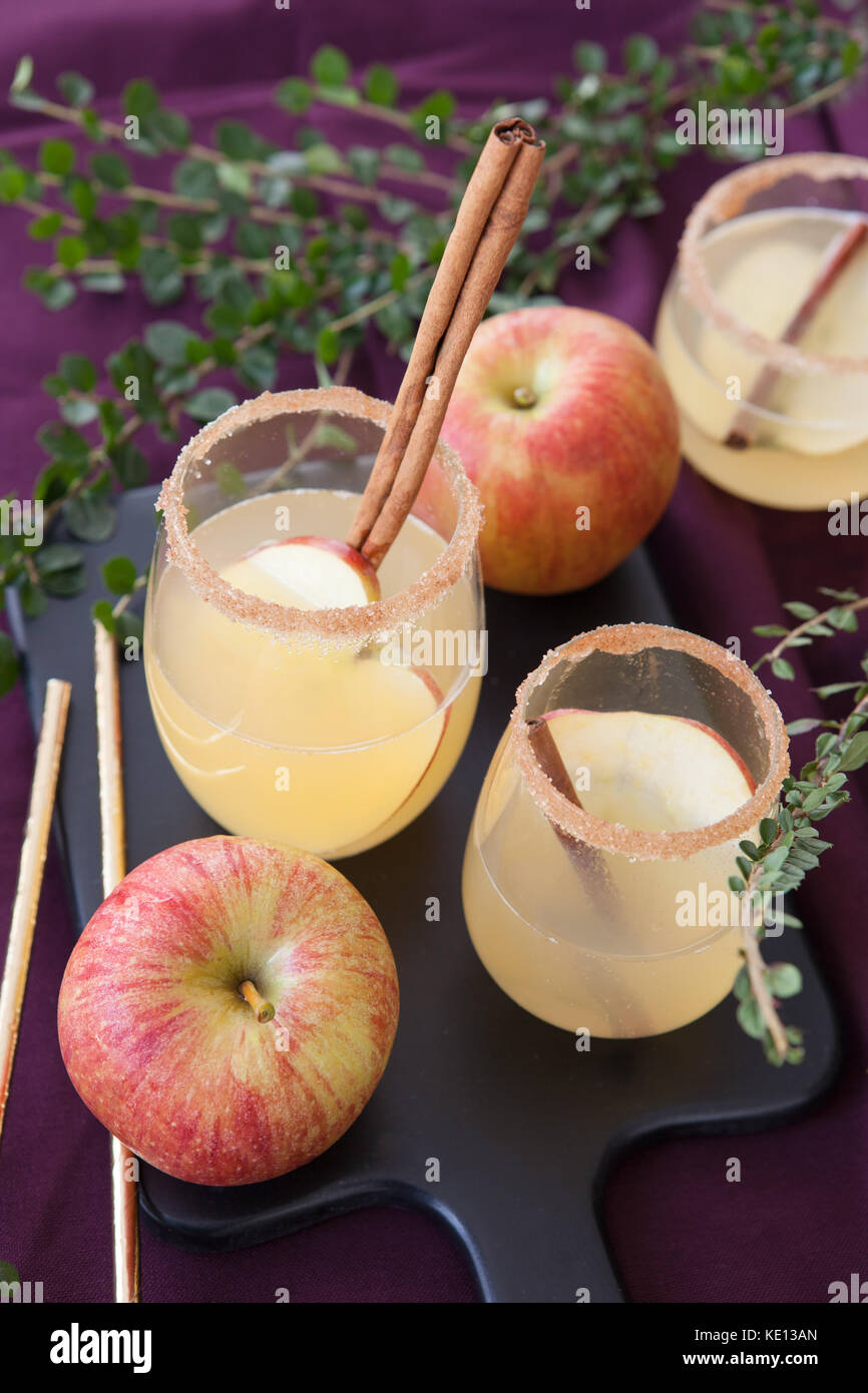 Fruity cocktail with apple and cinnamon sticks Stock Photo Alamy