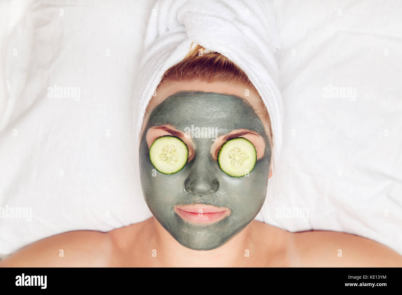 Attractive funny woman with a clay mask on her face. The concept of spa and  skin care Stock Photo - Alamy
