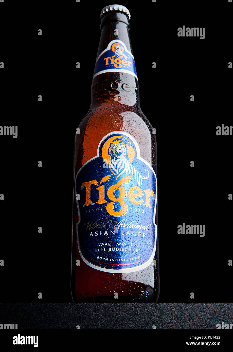 LONDON, UK, DECEMBER 15, 2016: Bottle of Tiger Beer on black background, First launched in 1932 is Singapore's first brewed beer. Stock Photo
