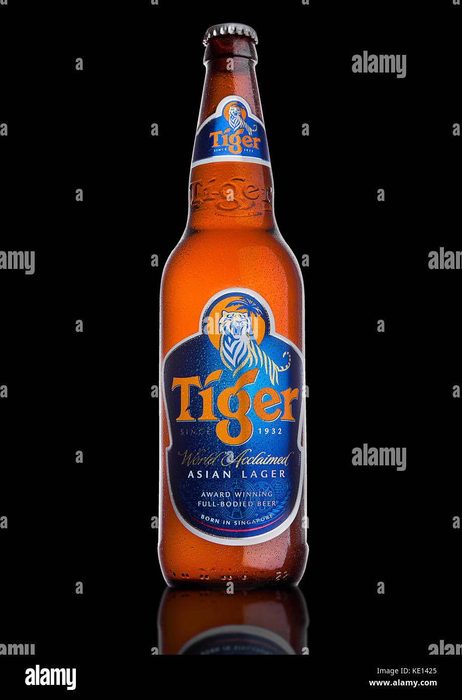 LONDON, UK, DECEMBER 15, 2016: Bottle of Tiger Beer on black background, First launched in 1932 is Singapore's first brewed beer. Stock Photo