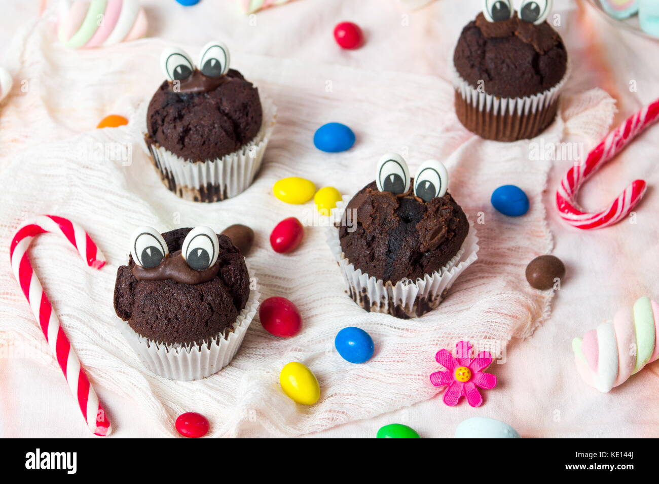 Chocolate Muffins With Edible Eyes And Colorful Bonbons Dessert