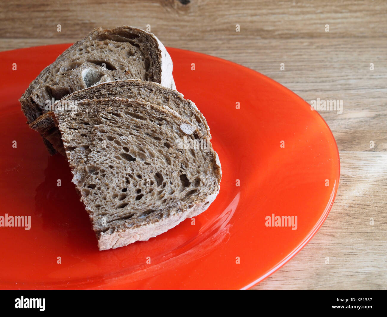 Malt rye bread on red plate Stock Photo Alamy