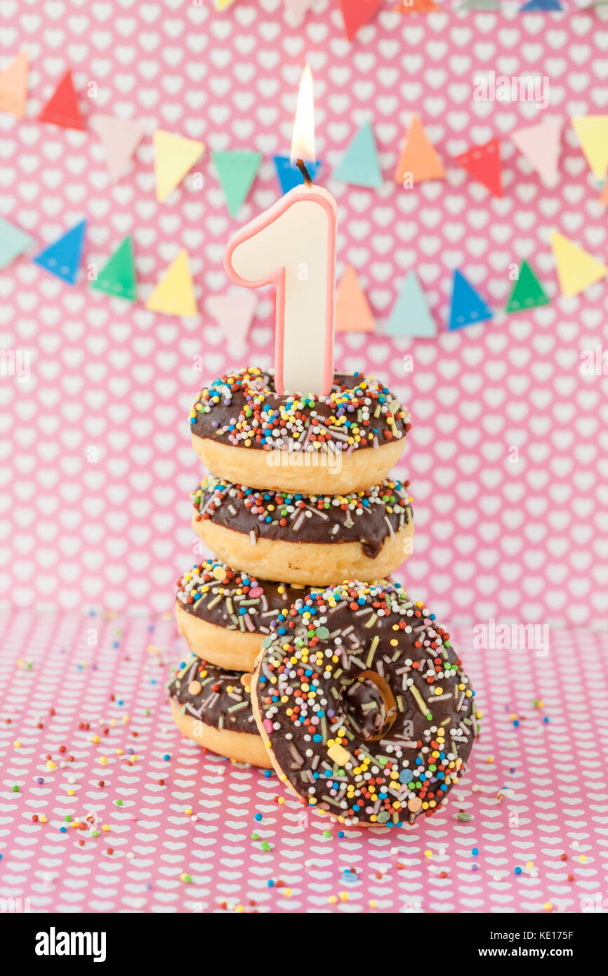 Stack of donuts with chocolate frosting and colorful sprinkles Stock Photo