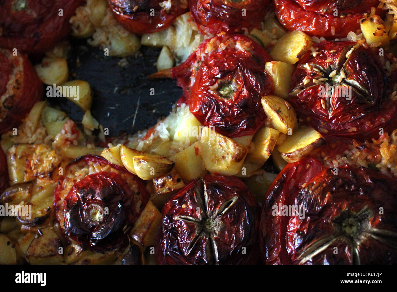 Italian rice stuffed tomatoes with potatoes Stock Photo