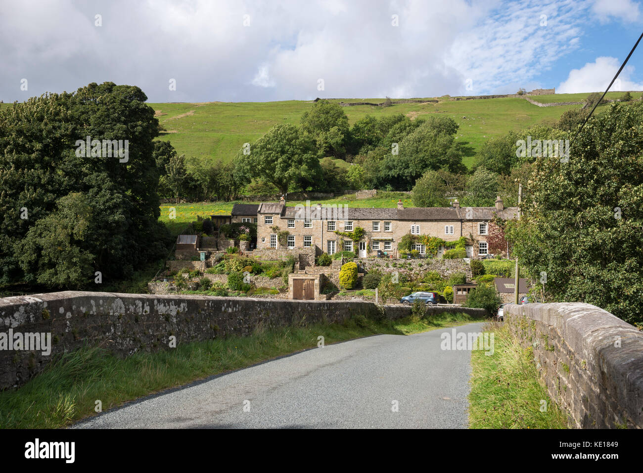 Row of Cottages beside the river Swale at Low Row in the Yorkshire Dales, England. Stock Photo